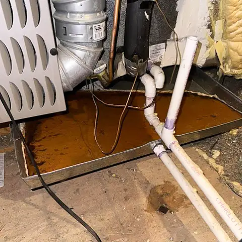 A rusted drain pan that needs to be replaced.