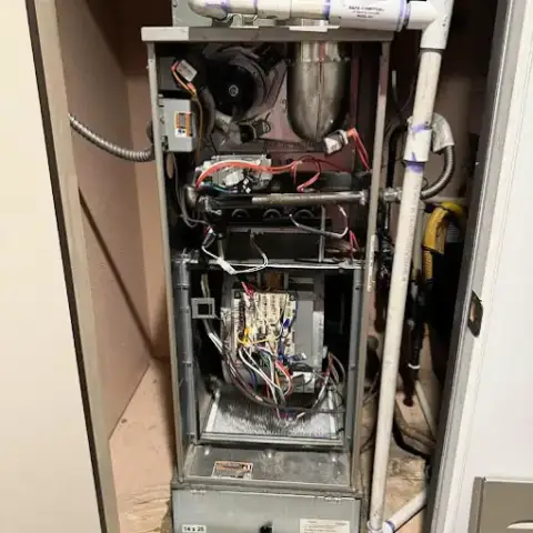 Completing a repair on a customer's indoor air handler unit.